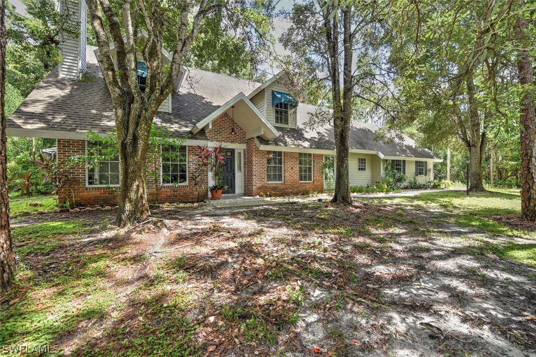 15180 Briar Ridge Circle Fort Myers, FL 33912 - Photo 4 of 35 front view of a house with a tree in the yard