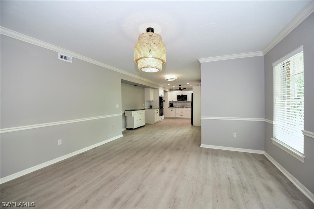 15180 Briar Ridge Circle Fort Myers, FL 33912 - Photo 9 of 35 wooden floor in an empty room with a window
