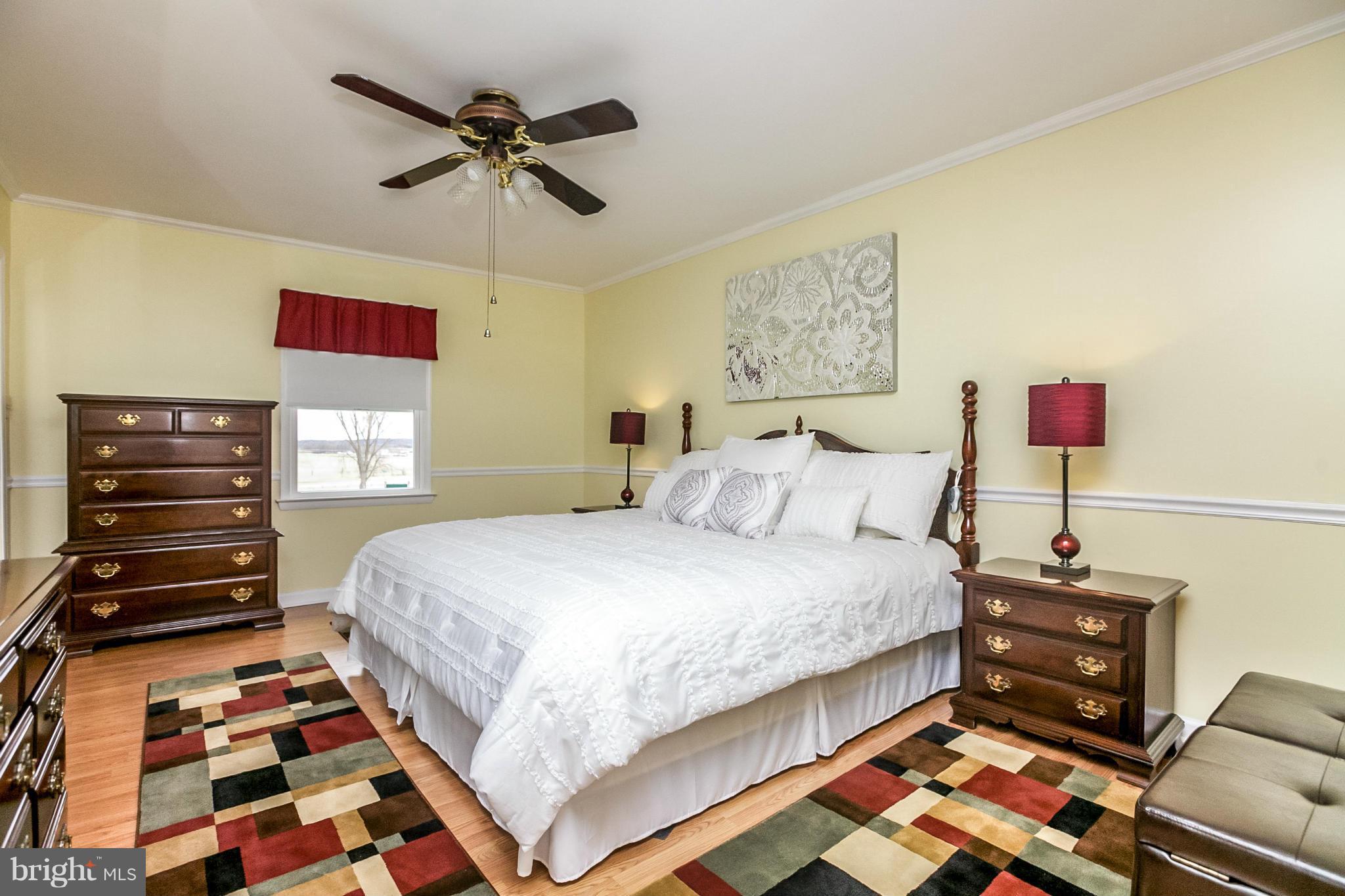 17216 Hunter Green Road Upperco, MD 21155 - Photo 14 of 30 a bedroom with a bed and wooden floor