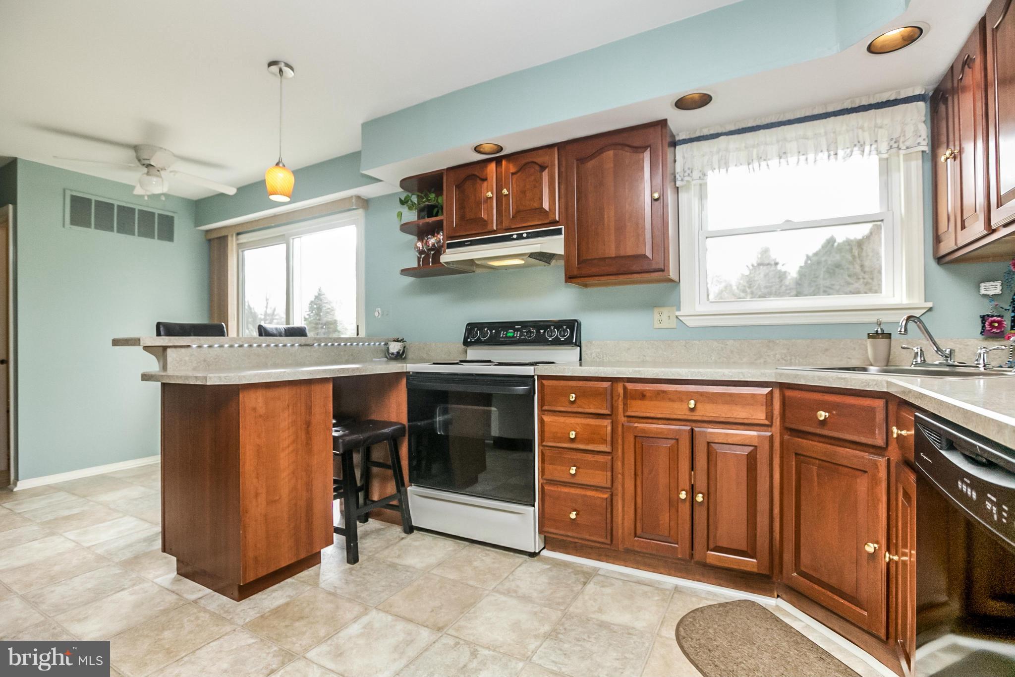 17216 Hunter Green Road Upperco, MD 21155 - Photo 8 of 30 a kitchen with stainless steel appliances granite countertop wooden cabinets a sink and a window