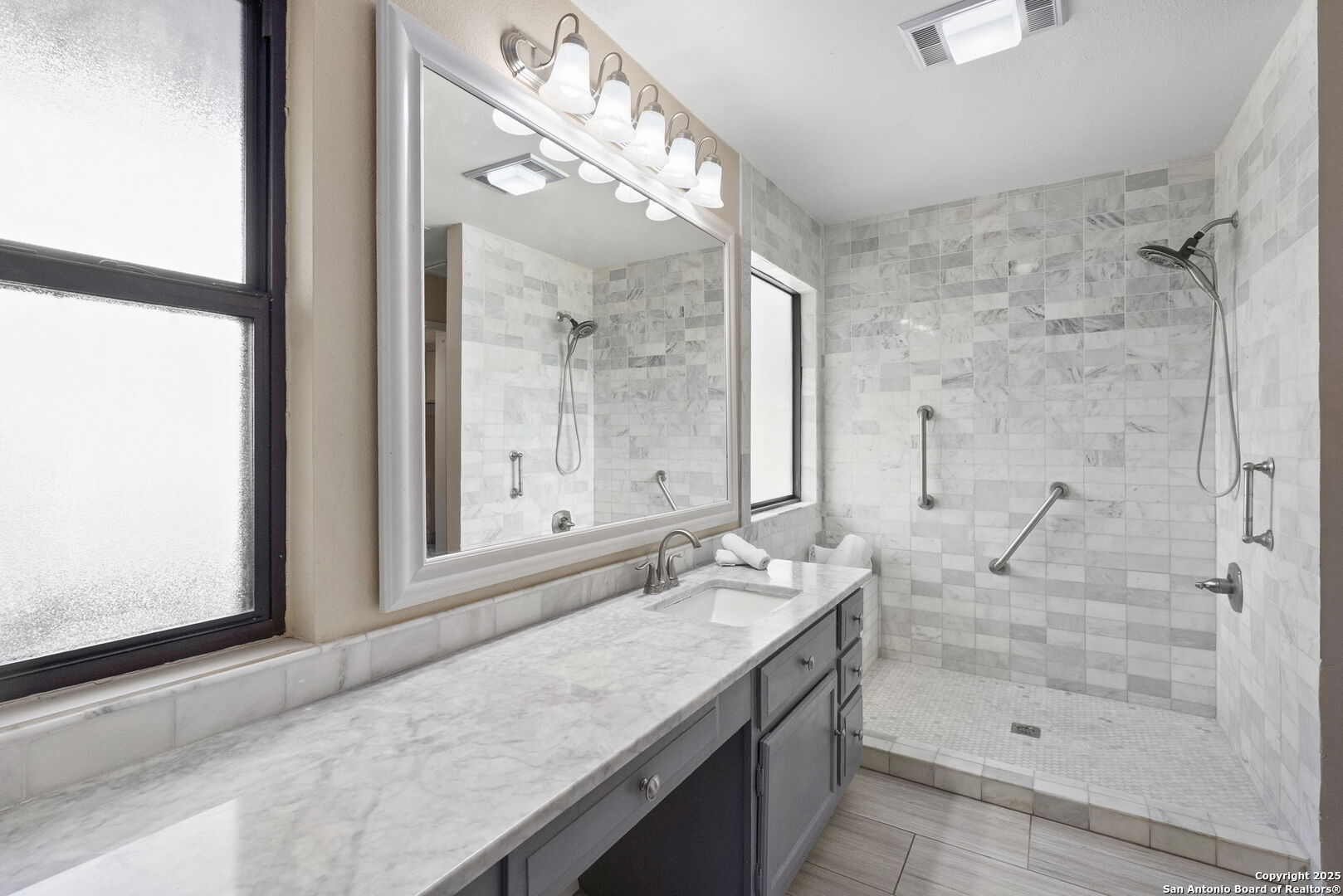 26938 Karsch Road Boerne, TX 78006 - Photo 30 of 60 a bathroom with a granite countertop sink a mirror and shower