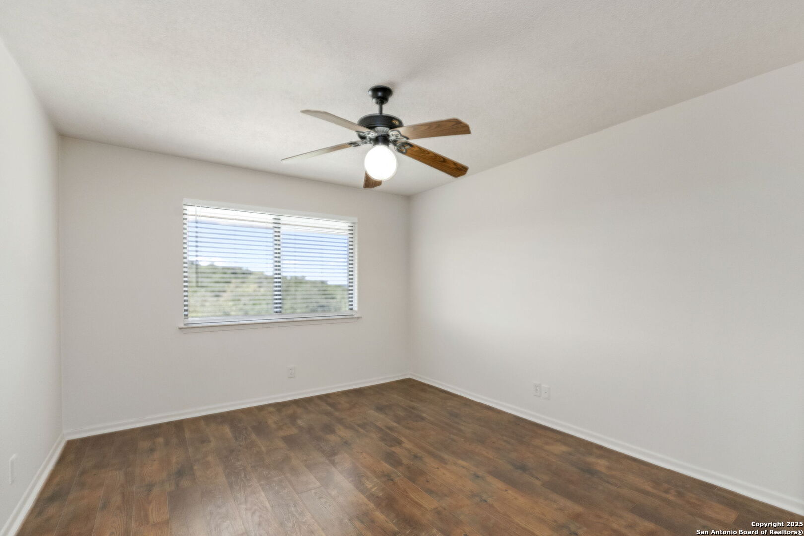 26938 Karsch Road Boerne, TX 78006 - Photo 33 of 60 an empty room with a window and a fan