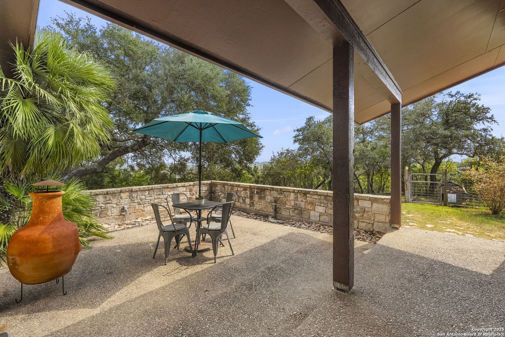 26938 Karsch Road Boerne, TX 78006 - Photo 39 of 60 a view of a patio with a table chairs and a umbrella