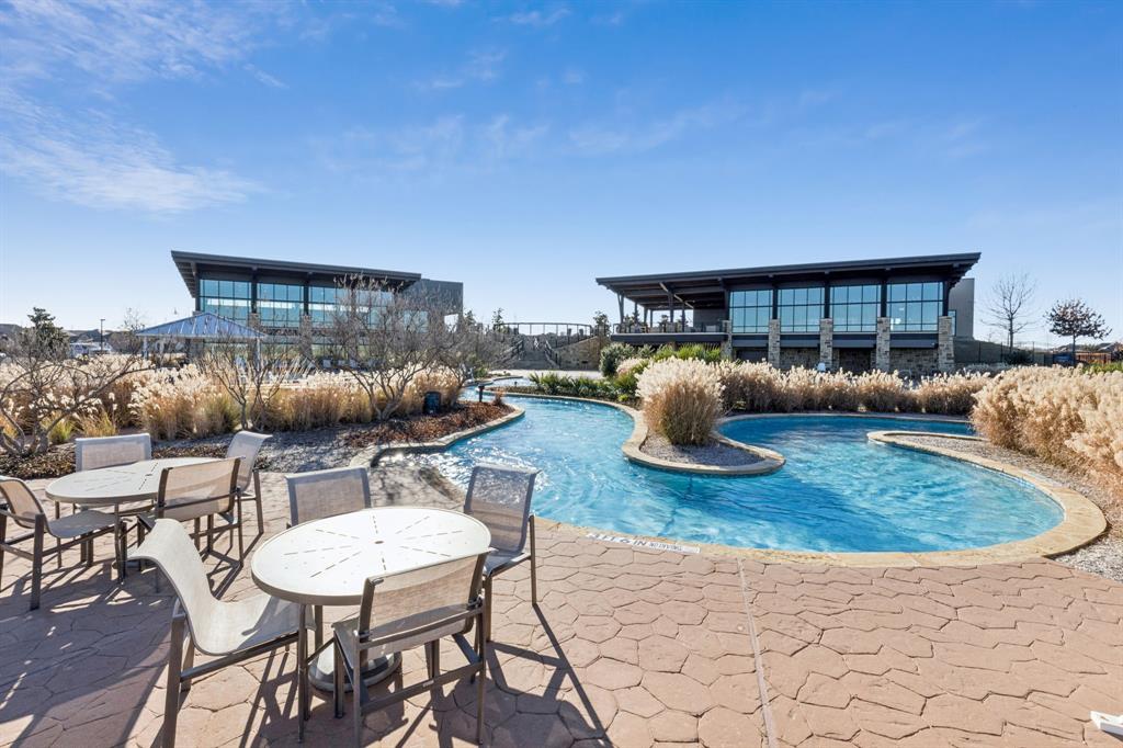 2015 April Dew Way Wylie, TX 75098 - Photo 11 of 20 a view of a patio with a dining table and chairs under an umbrella