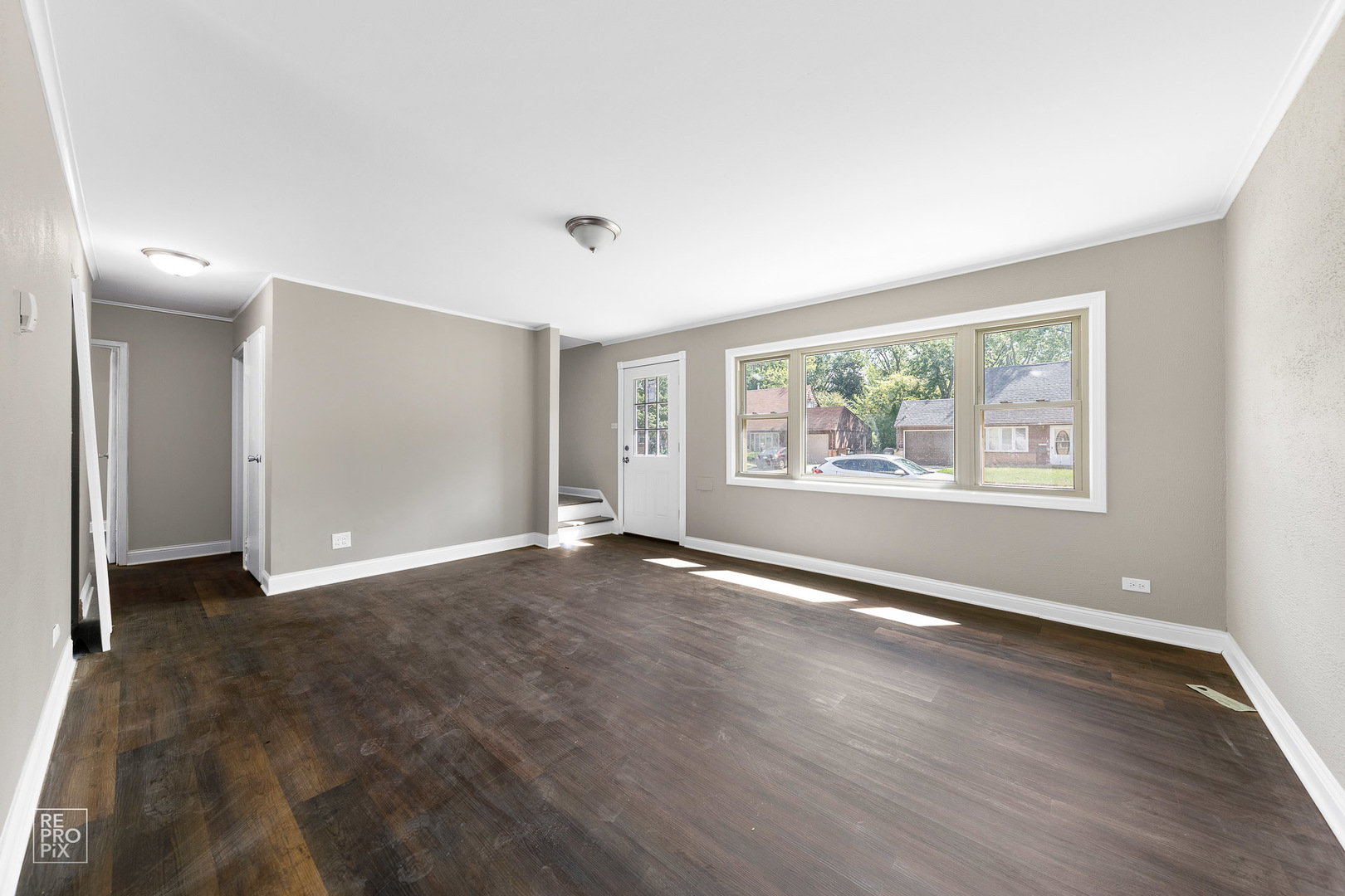 112 Walnut Street Park Forest, IL 60466 - Photo 2 of 9 a view of an empty room with a window and wooden floor