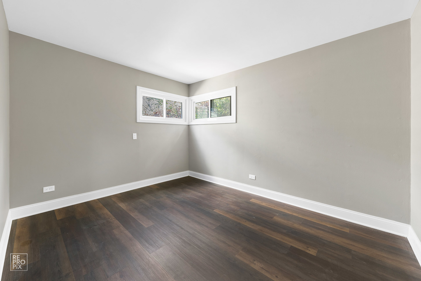 112 Walnut Street Park Forest, IL 60466 - Photo 3 of 9 a view of an empty room with wooden floor and a window
