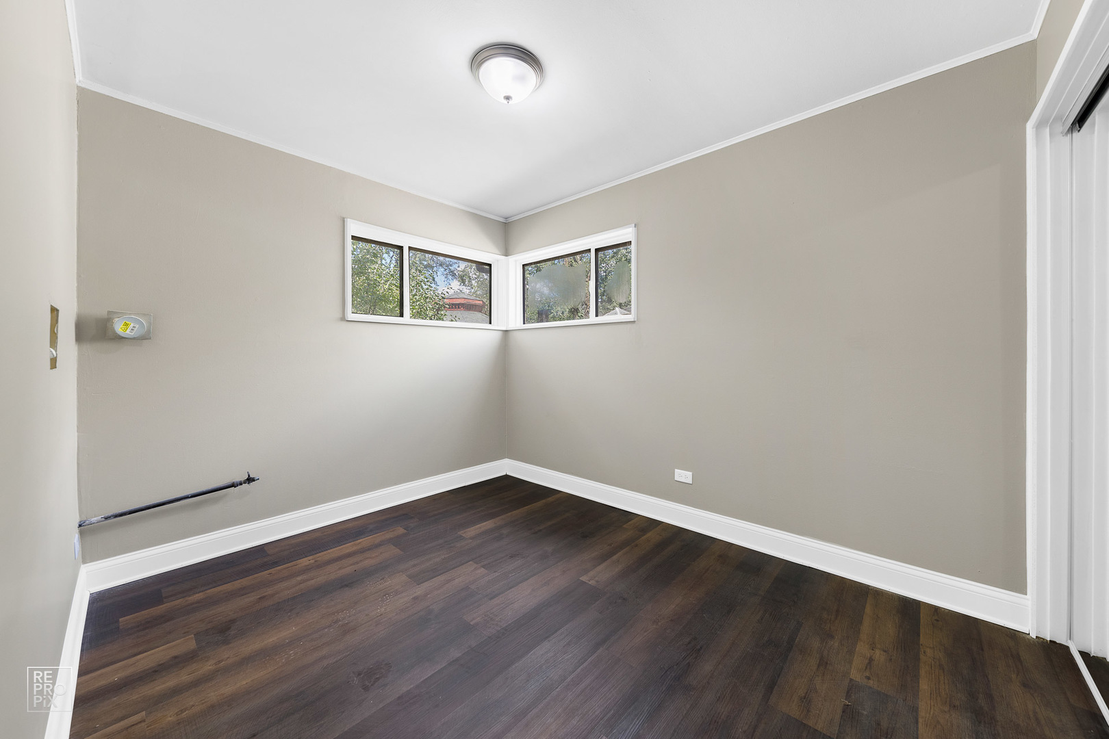 112 Walnut Street Park Forest, IL 60466 - Photo 4 of 9 a view of an empty room with wooden floor and a window