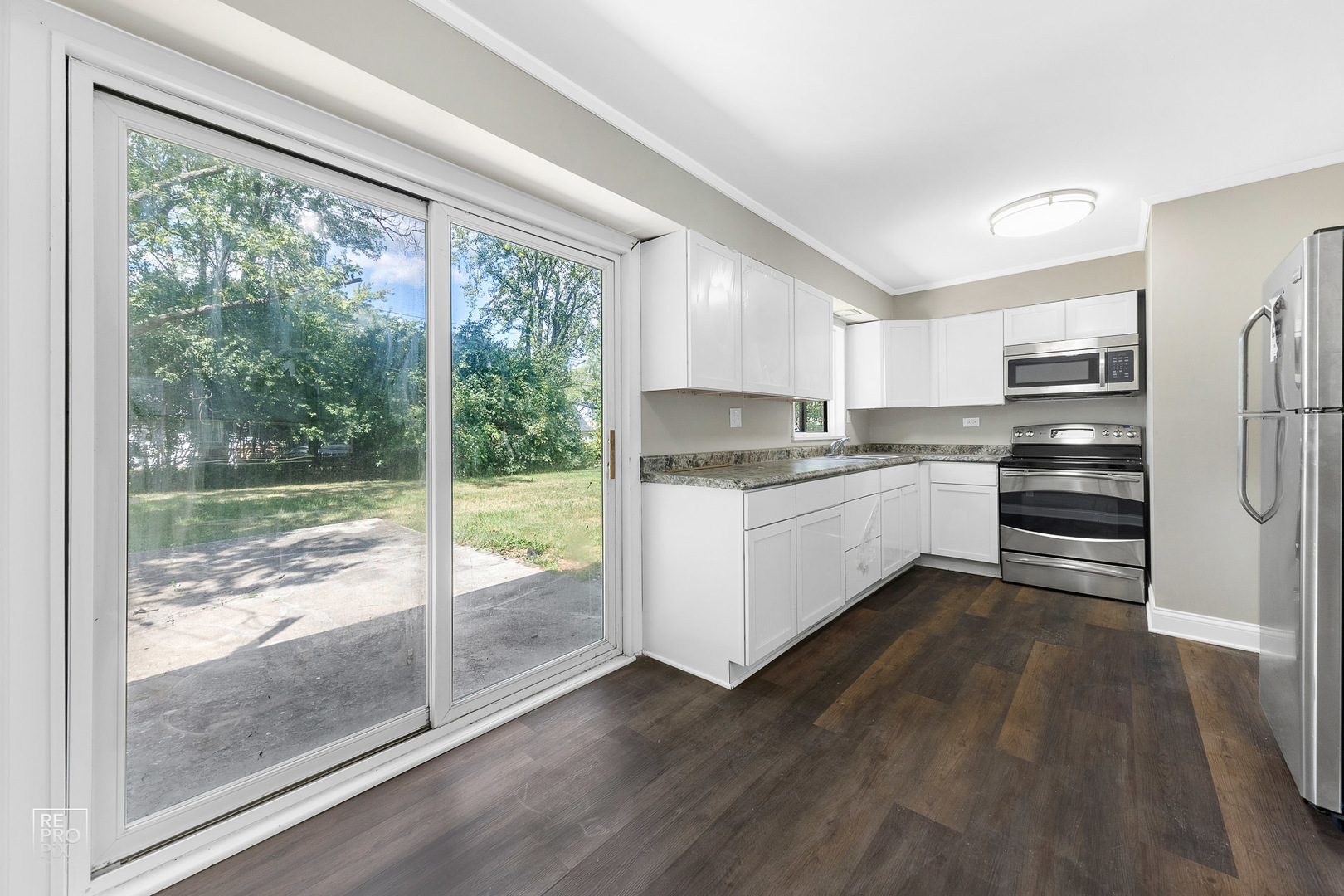 112 Walnut Street Park Forest, IL 60466 - Photo 5 of 9 a kitchen with a refrigerator a sink and cabinets