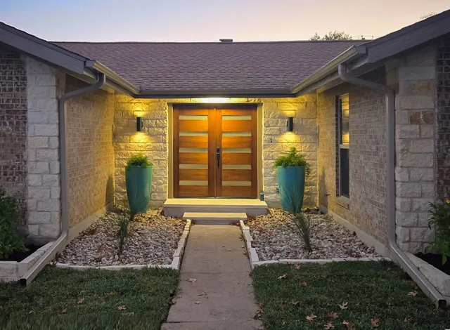 a large kitchen with cabinets wooden floor and stainless steel appliances