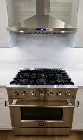 a bathroom with a toilet a sink a mirror a window and vanity