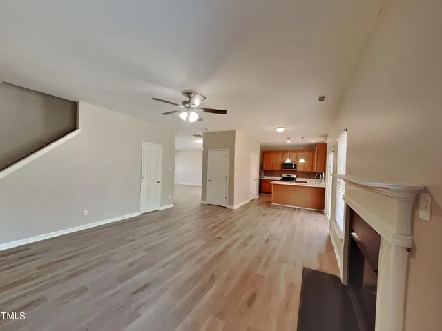 a view of a kitchen with wooden floor and a sink