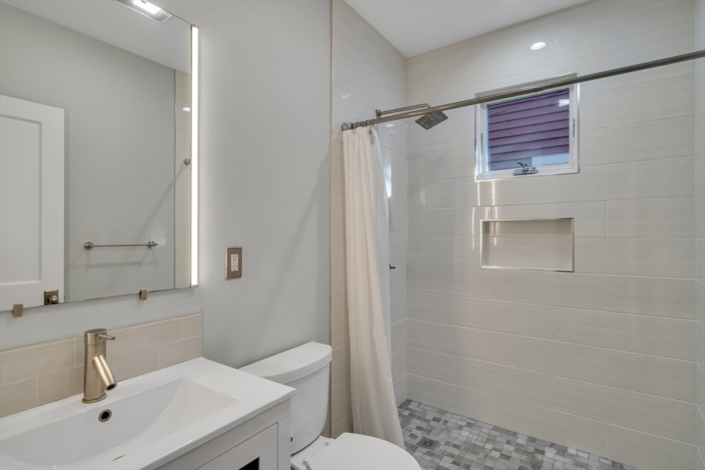 16 Traymore Street, Unit 16 Cambridge, MA 02140 - Photo 11 of 22 a bathroom with a sink a toilet and shower