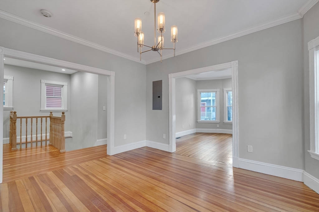 16 Traymore Street, Unit 16 Cambridge, MA 02140 - Photo 12 of 22 a view of an empty room with wooden floor and a window