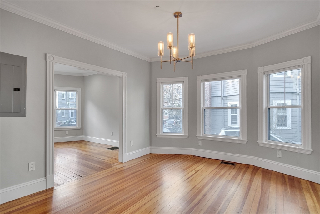 16 Traymore Street, Unit 16 Cambridge, MA 02140 - Photo 7 of 22 a view of an empty room with wooden floor and a window