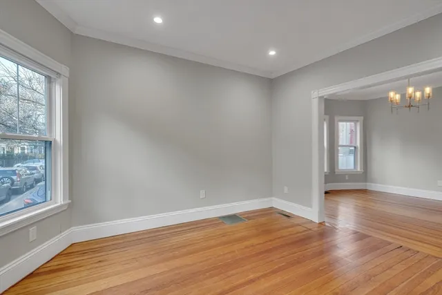 wooden floor in an empty room with a window