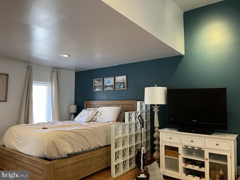 1202 South Street Philadelphia, PA 19147 - Photo 3 of 7 a bedroom with a bed and a flat screen tv