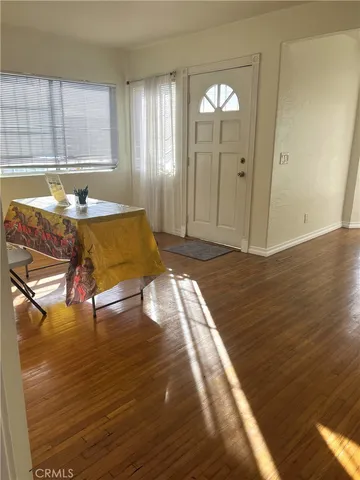 a view of a livingroom with furniture window and wooden floor