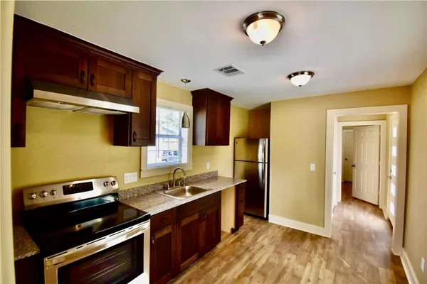 a kitchen with a sink appliances and cabinets