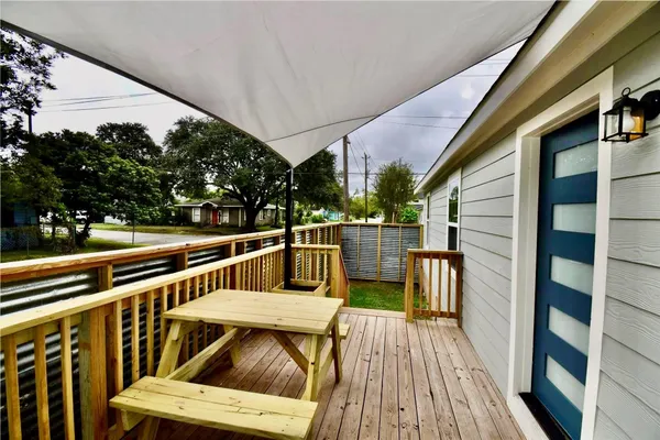 a view of deck with furniture and trees