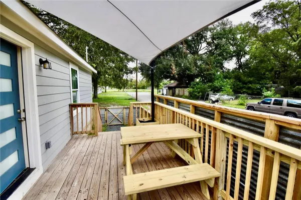 a view of a roof deck with wooden floor and fence