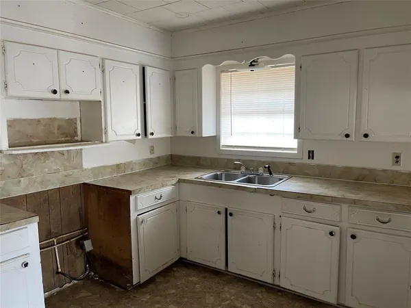 a kitchen with granite countertop white cabinets and white appliances
