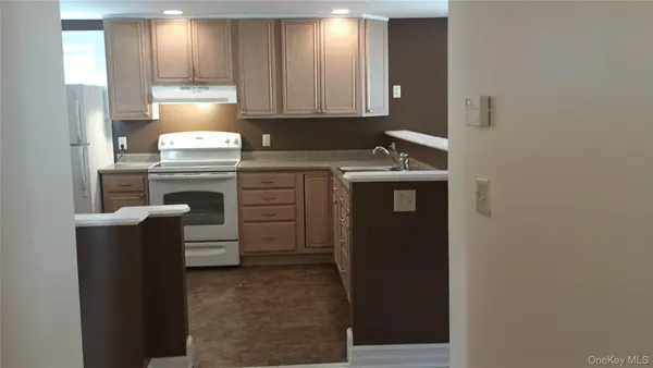 a kitchen with a refrigerator and a stove