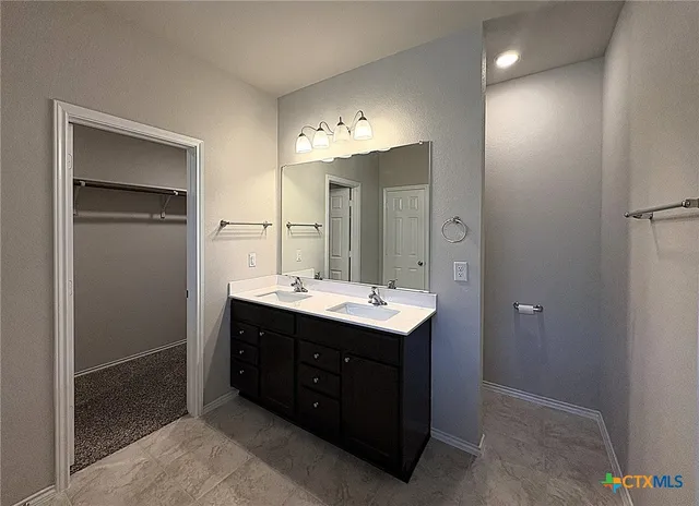 a bathroom with a sink and mirror
