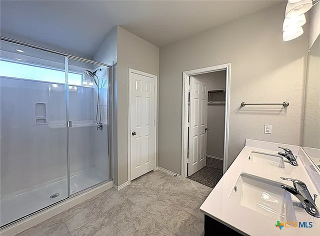 a bathroom with a sink and shower