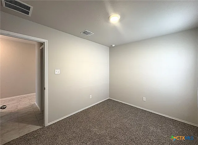 an empty room with a empty space and windows