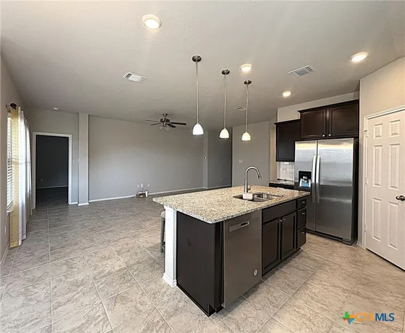 a kitchen with a stove and refrigerator