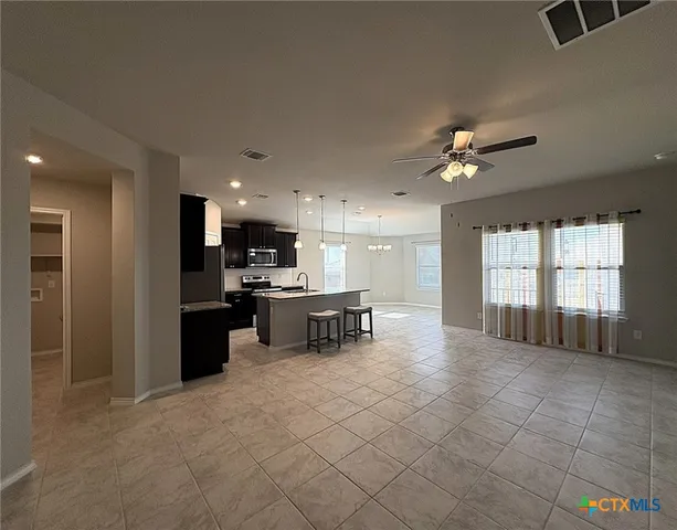 a view of kitchen with windows and chairs