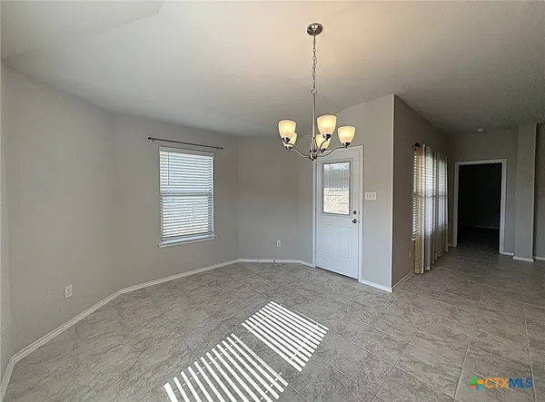 a view of a room with windows and ceiling fan