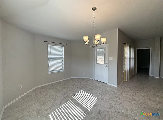 a view of a room with windows and ceiling fan