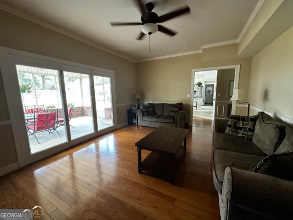 a living room with furniture and a floor to ceiling window