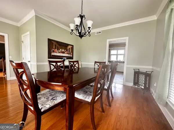 a view of a dining room with furniture window and wooden floor