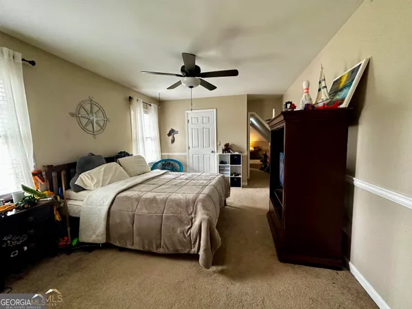 a bedroom with bed and a window