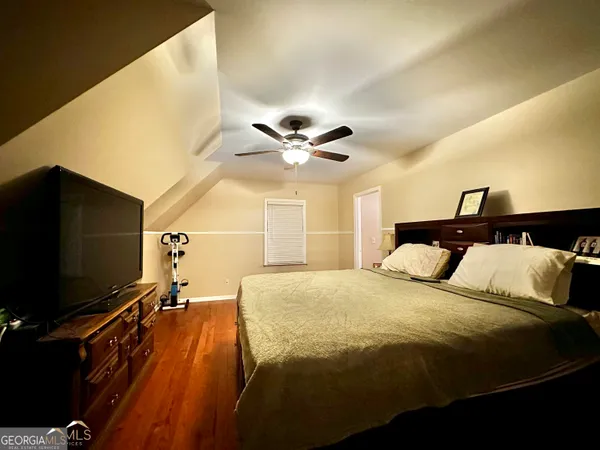 a bed room with a bed and a flat screen tv