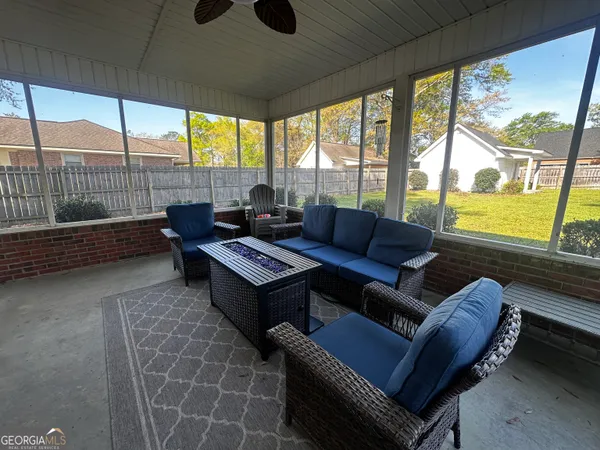 a swimming pool with outdoor seating and yard