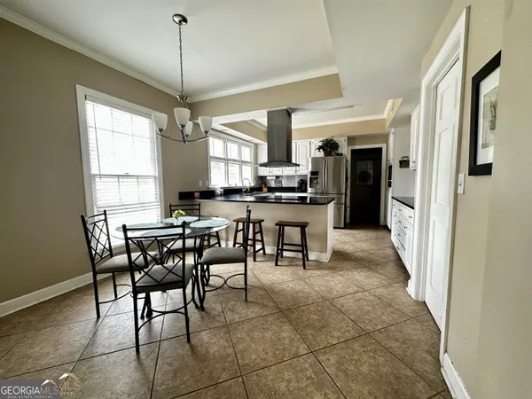 a view of a dining room with furniture and window