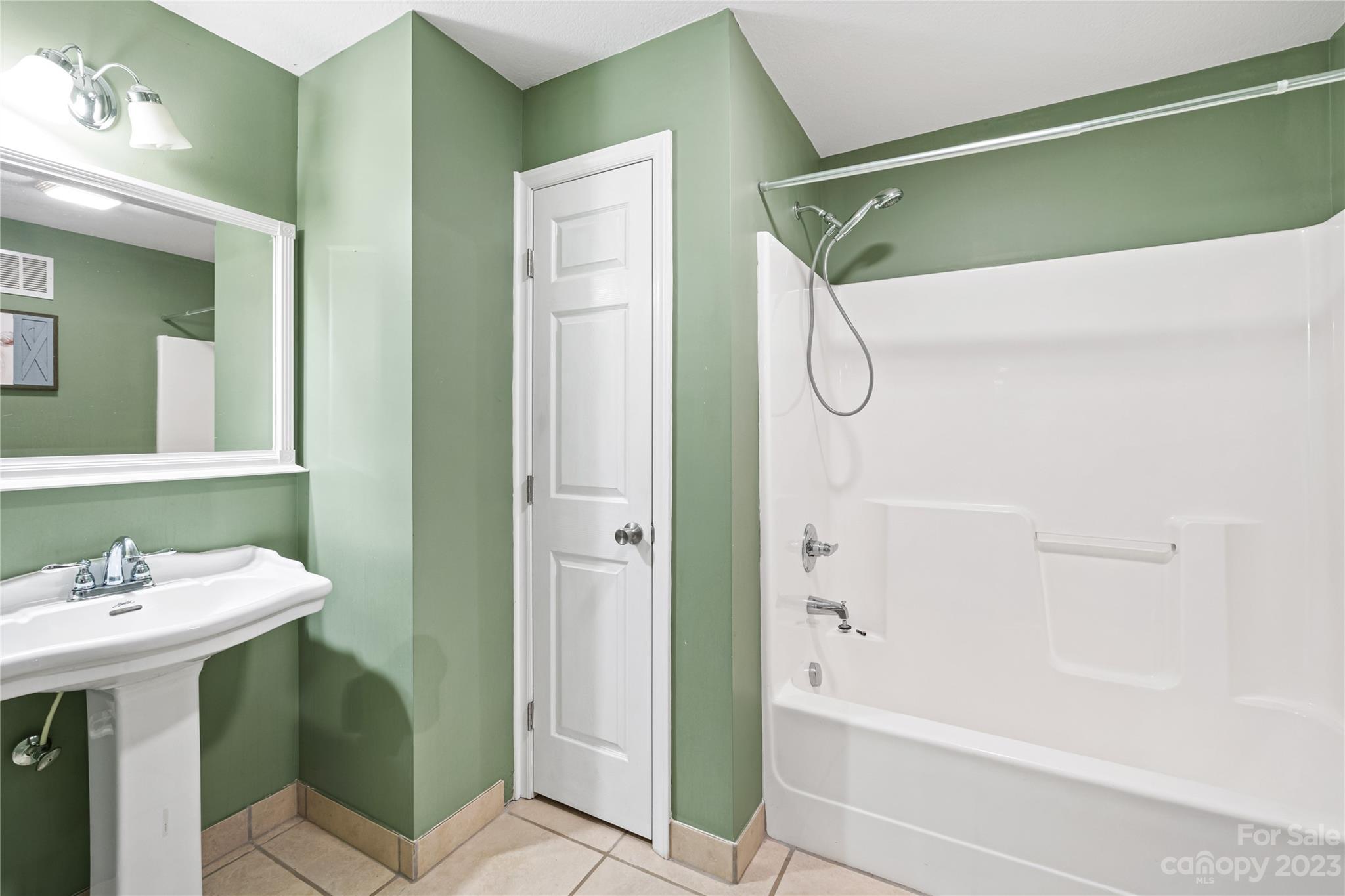 1463 Brookstone Drive Hickory, NC 28602 - Photo 22 of 40 a bathroom with a shower a sink and a mirror