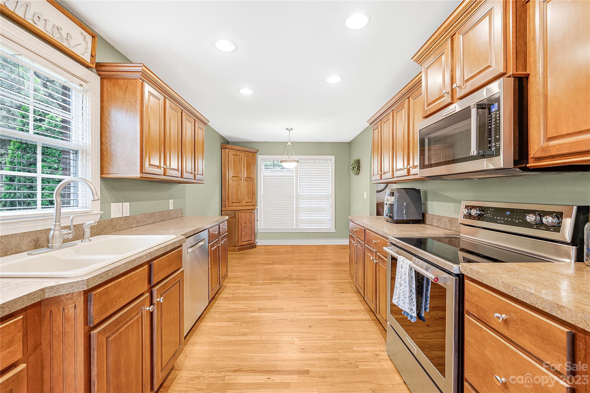 1463 Brookstone Drive Hickory, NC 28602 - Photo 7 of 40 a kitchen with stainless steel appliances granite countertop wooden cabinets a sink and a stove