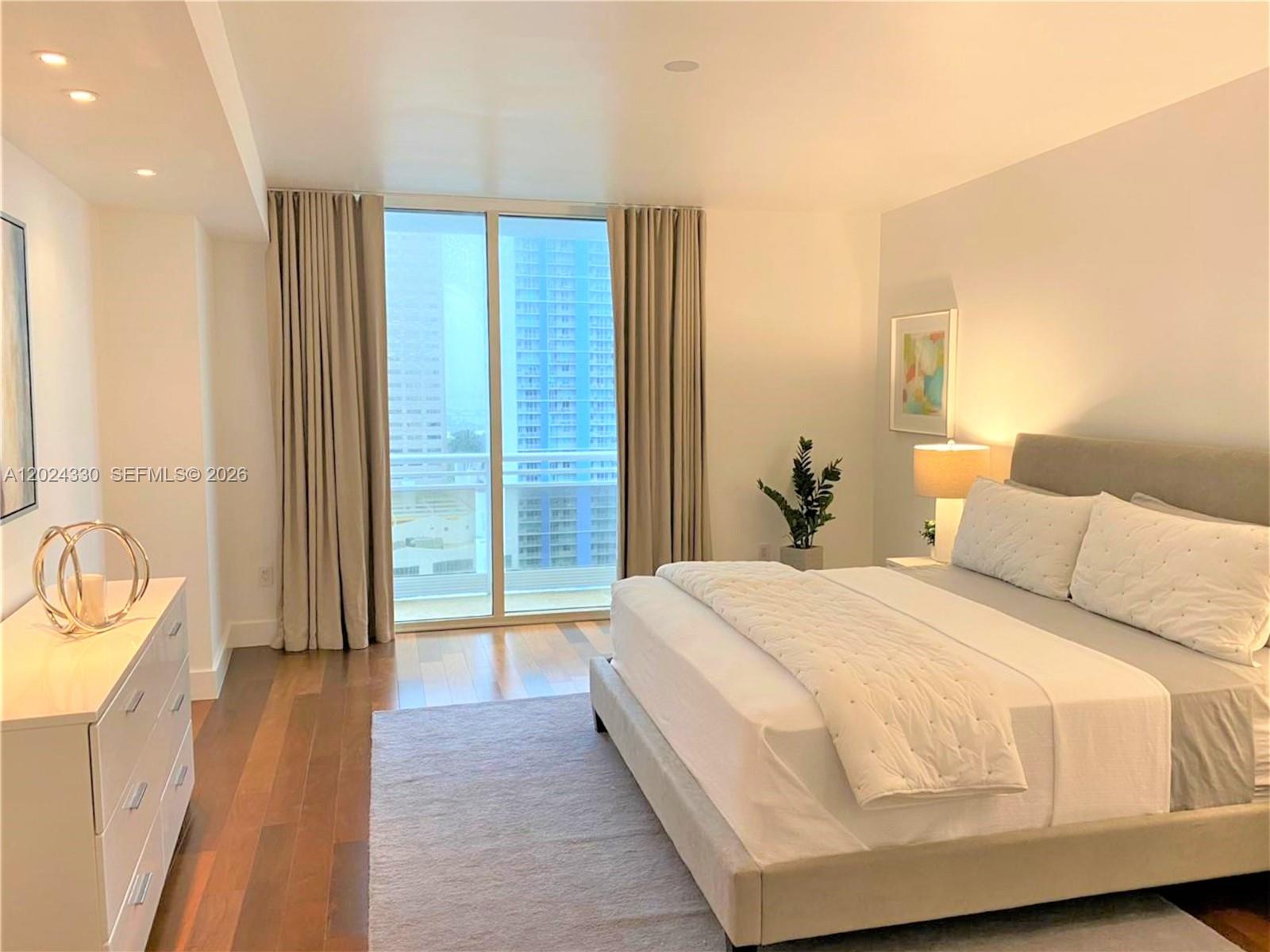 901 Brickell Key Boulevard, Unit 2006 Miami, FL 33131 - Photo 19 of 41 Spacious Primary Bedroom - Wood Floors - Recessed Lighting - Balcony