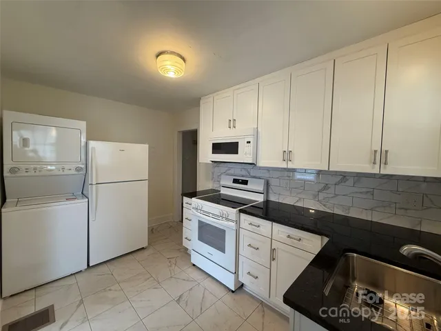 a kitchen with cabinets appliances and a counter space