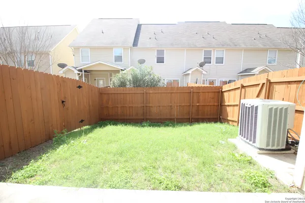 a view of a backyard with potted plants