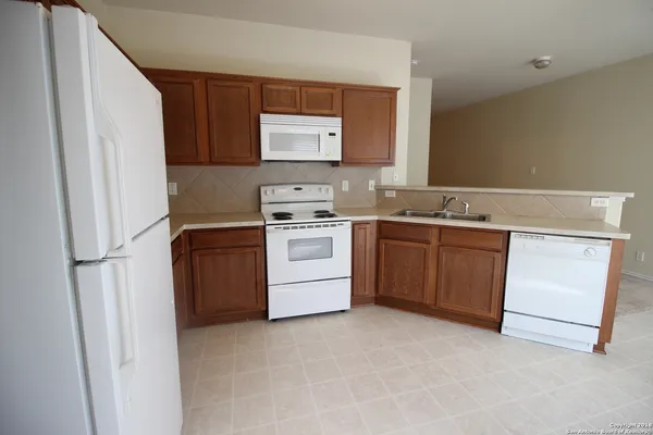 a kitchen with a stove sink and cabinets