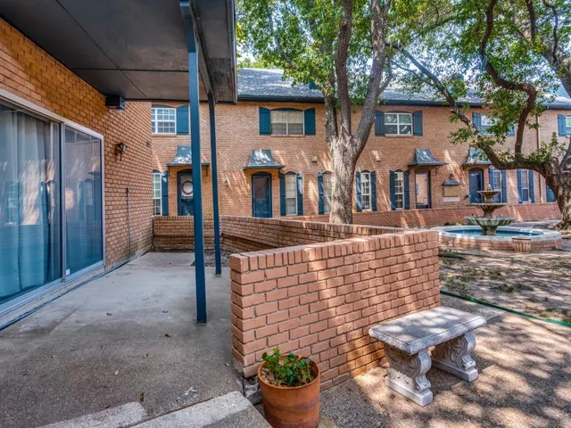a view of a patio with chair and tables