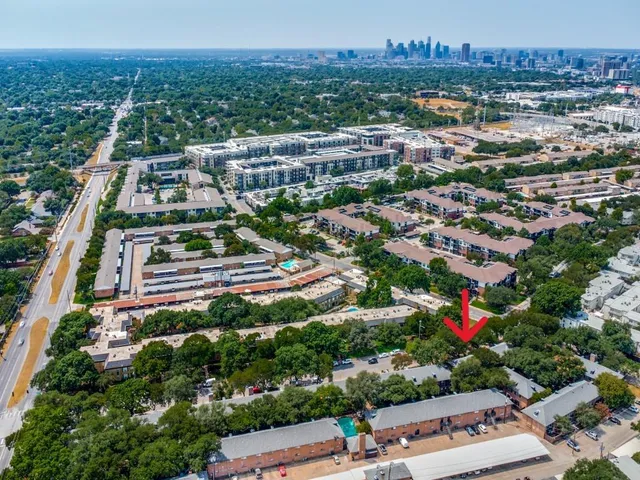 an aerial view of residential houses with city view
