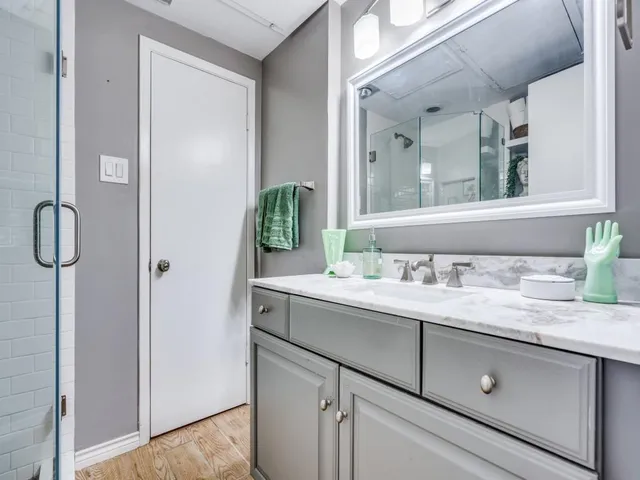a bathroom with a granite countertop sink and a mirror