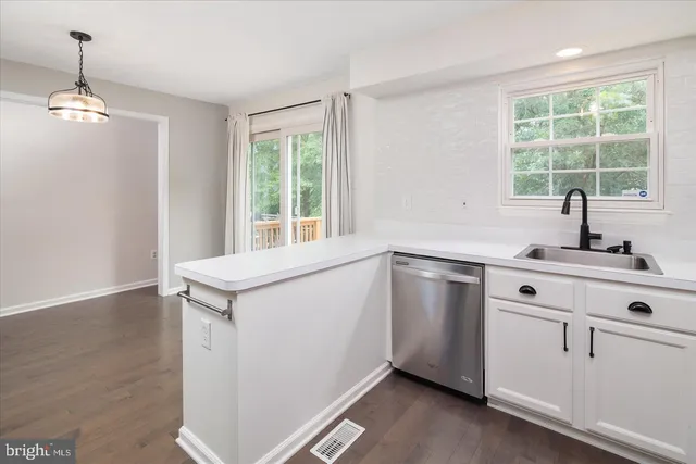 a utility room with cabinets washer and dryer