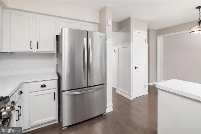 a kitchen with stainless steel appliances a refrigerator and a stove top oven